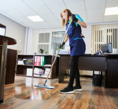 woman janitor cleaning wood floor